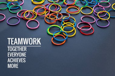 Teamwork concept. group of colorful rubber band on black background with word Teamwork, Together, Everyone, Achieves and More clipart