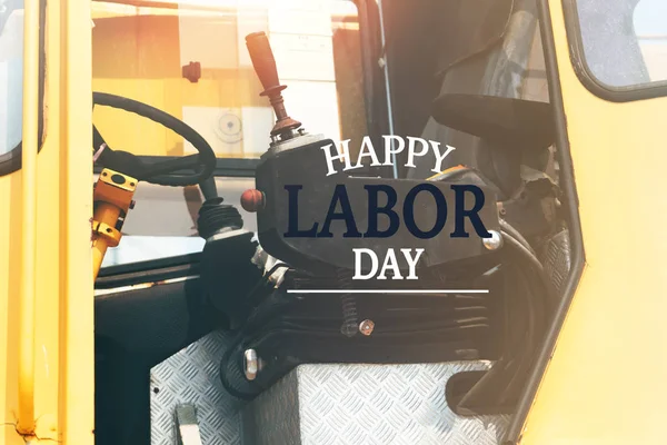 Labor Day Concept. excavator driver seat closeup with word Happy Labor Day