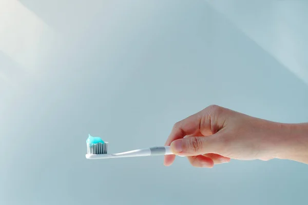 Woman Hand Holding Toothbrush Toothpaste Applied Closeup White Toothbrush Blue — Stock Photo, Image