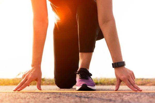 Ready go. running woman on start position and going to run on long road