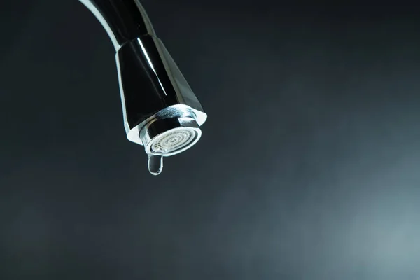 world water day, water drop on faucet with  black backgrounds