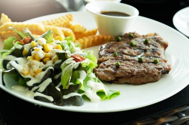 Izgara biftek ve patates kızartılmış sebze salatası. Ev yapımı 