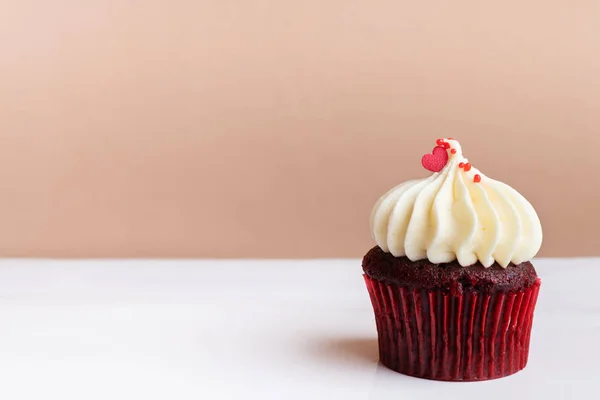 Happy Mothers Day, sweet red heart on white cream cupcake