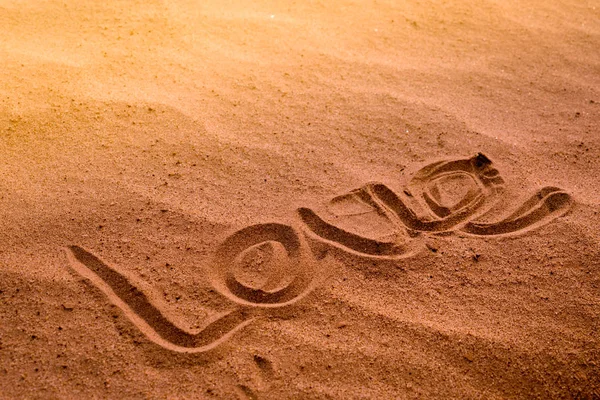 LOVE word writing on nature sand on the beach. summer trip