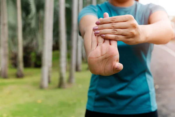 Mulher esporte alongamento antebraço antes do exercício. esporte ao ar livre e conceito de atividades de exercício — Fotografia de Stock