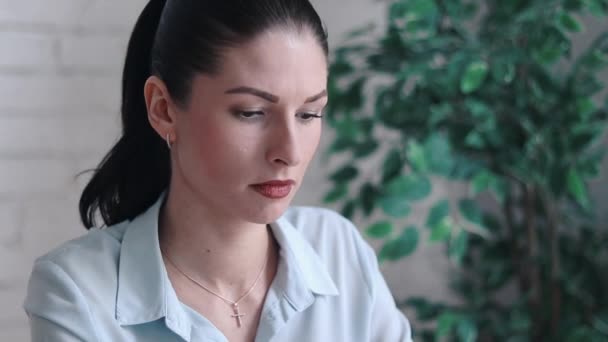 Mulher de negócios com dor de cabeça enquanto trabalhava usando computador portátil. Menina estressada e deprimida tocando sua cabeça, sentando dor enquanto se senta na mesa de madeira no café. Conceito de Falha no Trabalho — Vídeo de Stock