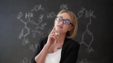 formül kendine güvenen güzel bir kadın öğretmenin tebeşir yazı tahtası arka plan bilim veya kimya öğrenmek