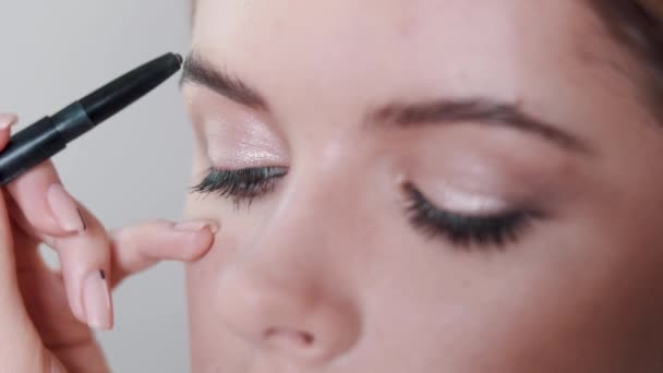 Visagiste peint les yeux avec fard à paupières une jeune fille — Video