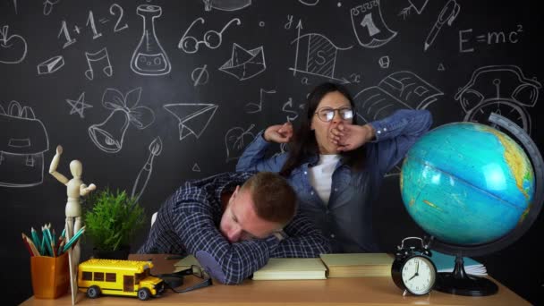 Young students, schoolchildren study hard in the library. University students conduct research in the library with books on the table. For the concept of diversity the school of education — Stock Video