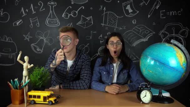 Young students, schoolchildren study hard in the library. University students conduct research in the library with books on the table. For the concept of diversity the school of education — Stock Video