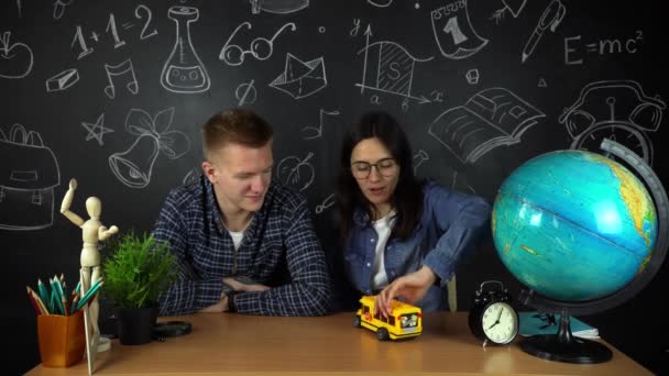 Young students, schoolchildren study hard in the library. University students conduct research in the library with books on the table. For the concept of diversity the school of education — Stock Video