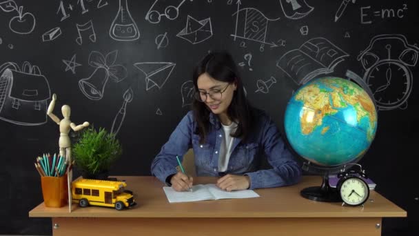 Schoolgirl, student sitting at a Desk, doing homework. Education at school, College, University — Stock Video