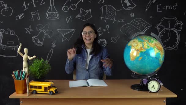 Schoolgirl, student sitting at a Desk, doing homework. Education at school, College, University — Stock Video