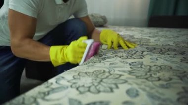 Temizlik şirketi koltuk Temizleme meşgul bir adam. Temizleyici temizlik bezi kuru buhar ile tek tip kanepe adam.