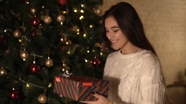 Žena otevírá nový rok dárek pod vánoční stromeček — Stock video