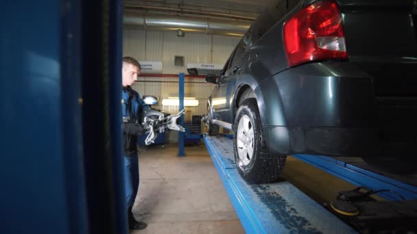 Automobilové kolo upevněné pomocí počítačového stroje na seřízení kol — Stock video