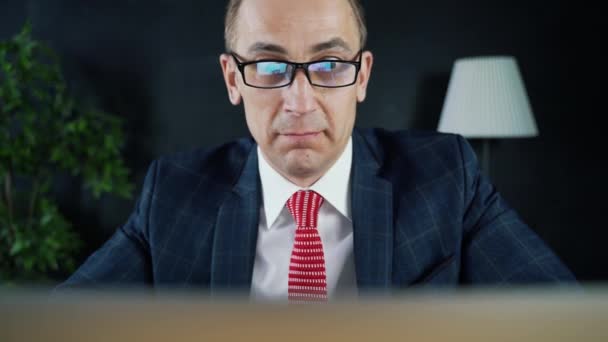 Adam işadamı ya da önünde bir dizüstü bilgisayar, iş yerinde oturan avukat. — Stok video