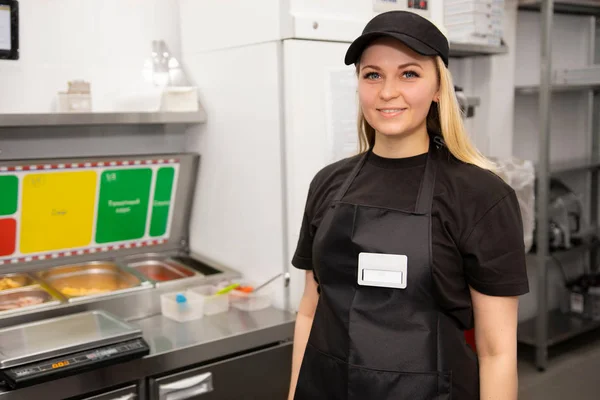 Woman wearing apron smiling welcoming guests having prosperous catering business concept