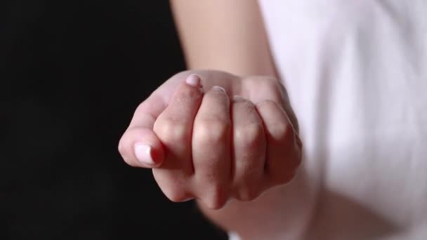 Close-up shot of a hand holding color pills on background — Stock Video