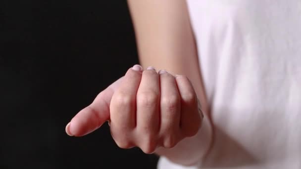 Close-up shot of a hand holding color pills on background — Stock Video