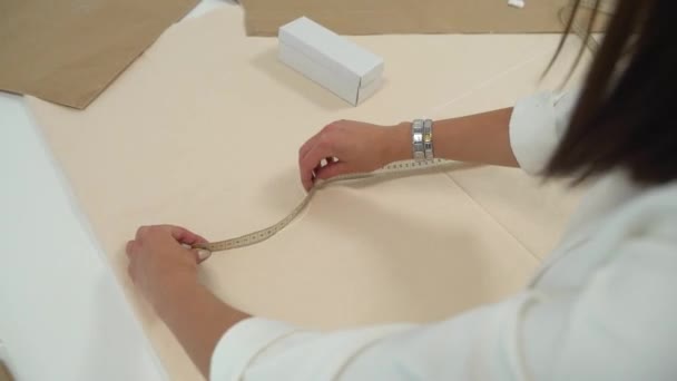 Pigen måler stoffet med et målemeter – Stock-video
