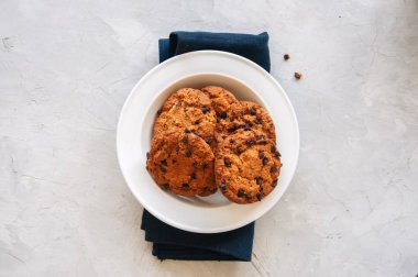 Beyaz bir tabak içinde ev yapımı çikolata parçalı kurabiye. En iyi görünüm ve kopya alanı.