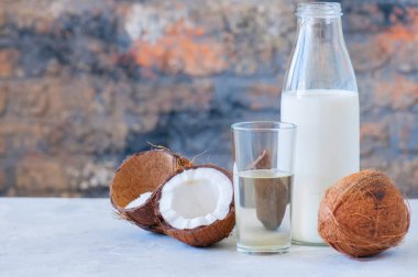 Bütün Hindistan cevizi ve Hindistan cevizi ürünler olarak su ve süt. Beyaz taş zemin.