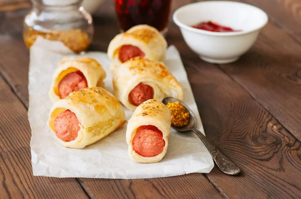 Varkens Een Planket Bladerdeeg Rolletjes Met Worst Een Houten Achtergrond — Stockfoto