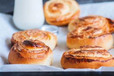 Süzme peynirli ev yapımı mayalı çörekler sütle doluyor. Kapat..