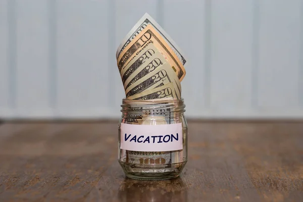 Vacation budget concept. Vacation money savings in glass jar