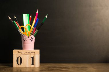 1 Eylül siyah kara tahta arka plan ile okul malzemeleri takvimi ayarlayın. Geri okul kavramı. Öğrenci çalışma alanı arka plan