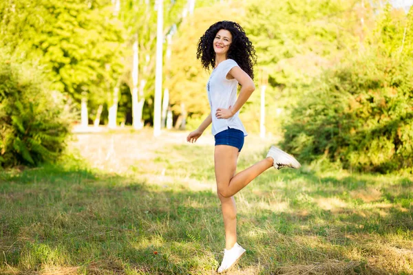Pretty Curly Woman Jeans Shorts Jumping Happiness — Stock Photo, Image