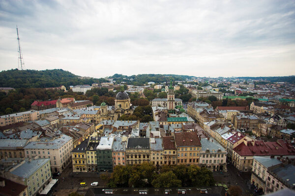 Aerial view old european city with rainy clouds on background