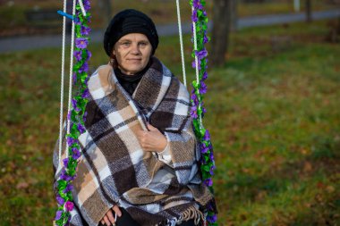 Sonbahar hızıyla battaniye otur kaplı çekici orta yaşlı kadın