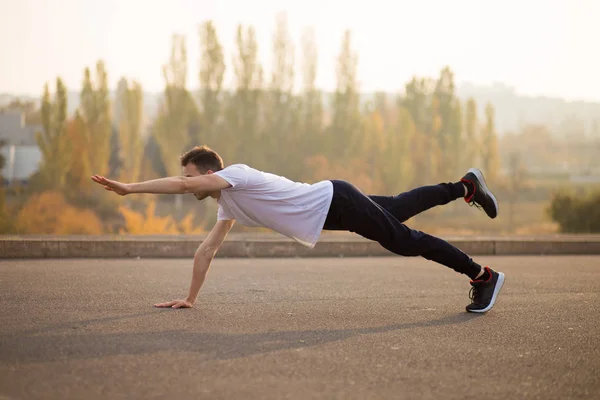 Young athletic man doing push up outdoors. Athletic man. Guy engaged in sports on nature. Sport life.