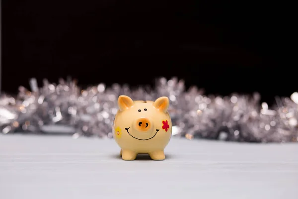 Funny piggy bank on dark background. Symbol Celebration to change 2019 year