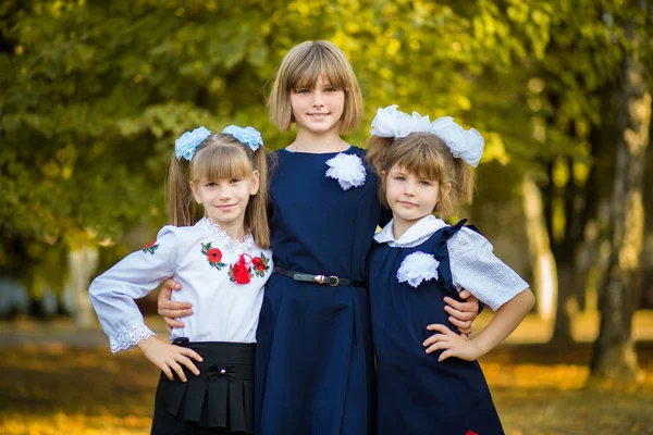 Three Happy Sisters Hug Autumn Park School Uniform Together Big — Stock Photo, Image