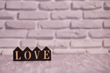 Metin seviyorum beyaz tuğla arka plana sahip siyah ahşap bloklar.