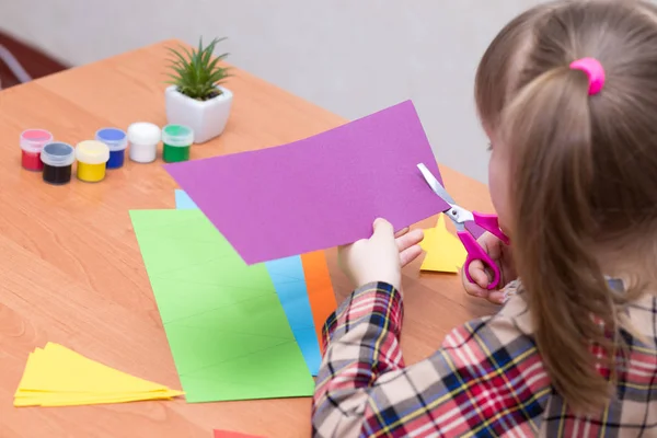 Küçük kız masada hediyeler yapar. El yapımı