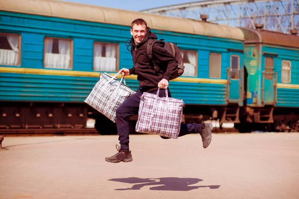 man with big bags at railway station. Travel by train