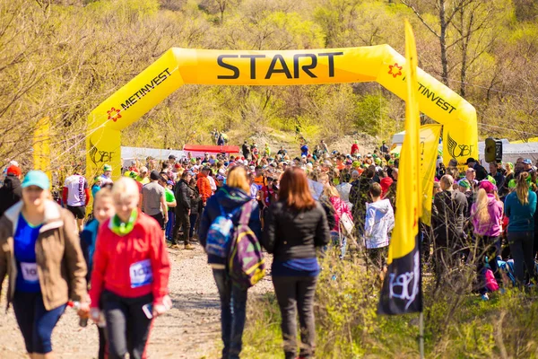 stock image Krivoy Rog, Ukraine - 21 April, 2019: Group of young athletes in start position. Fit young people preparing for Marathon participants distance start