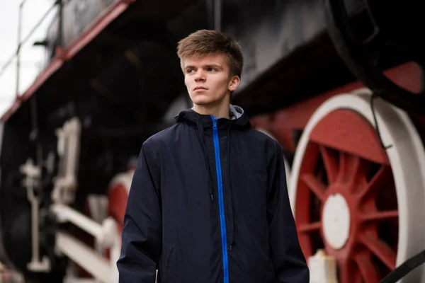 Young student man wait on Old Steam Train. Travel concept. future engineer technologist