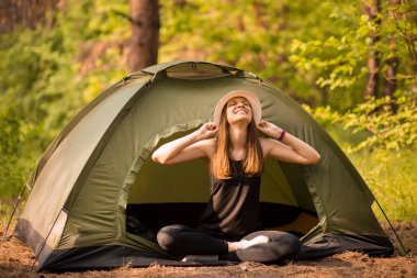 Çadır Dışında gün doğumu zevk elleri ile Mutlu hipster sevimli genç kız. ormanda kamp.