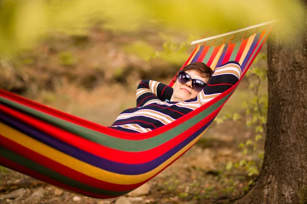 Senior woman relaxing in hammock in forest — Stock Photo, Image