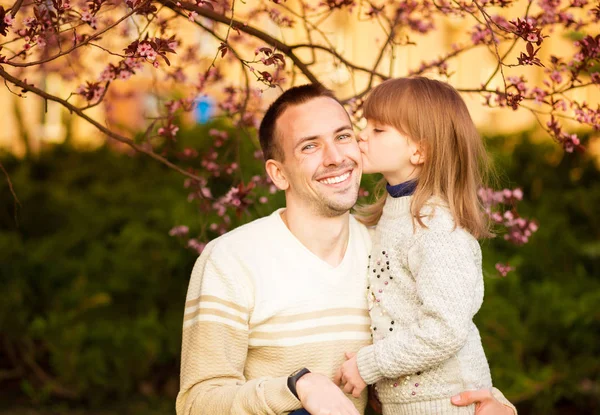 Close up portrait pretty daughter embracing Caucasian father. Family enjoy spend time together. Happy diverse family