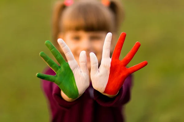 Painted kid hands in italy flag colors. Creative