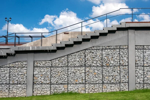 stock image RAYONG - 6 May 2018 : Gabion wall made of steel mesh and stairs up the terrace at Pararesort Thailand. with the sky as a backdrop.