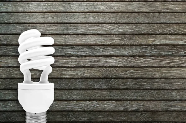 Fluorescent Light Bulb on wooden background