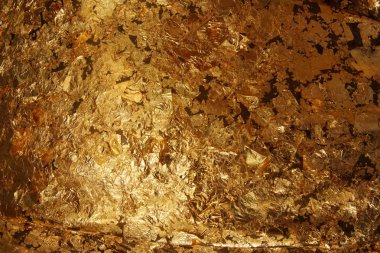 Koyu altın varak folyo doku arka plan.