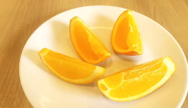 Sliced orange placed on a white plate. — Stock Photo, Image